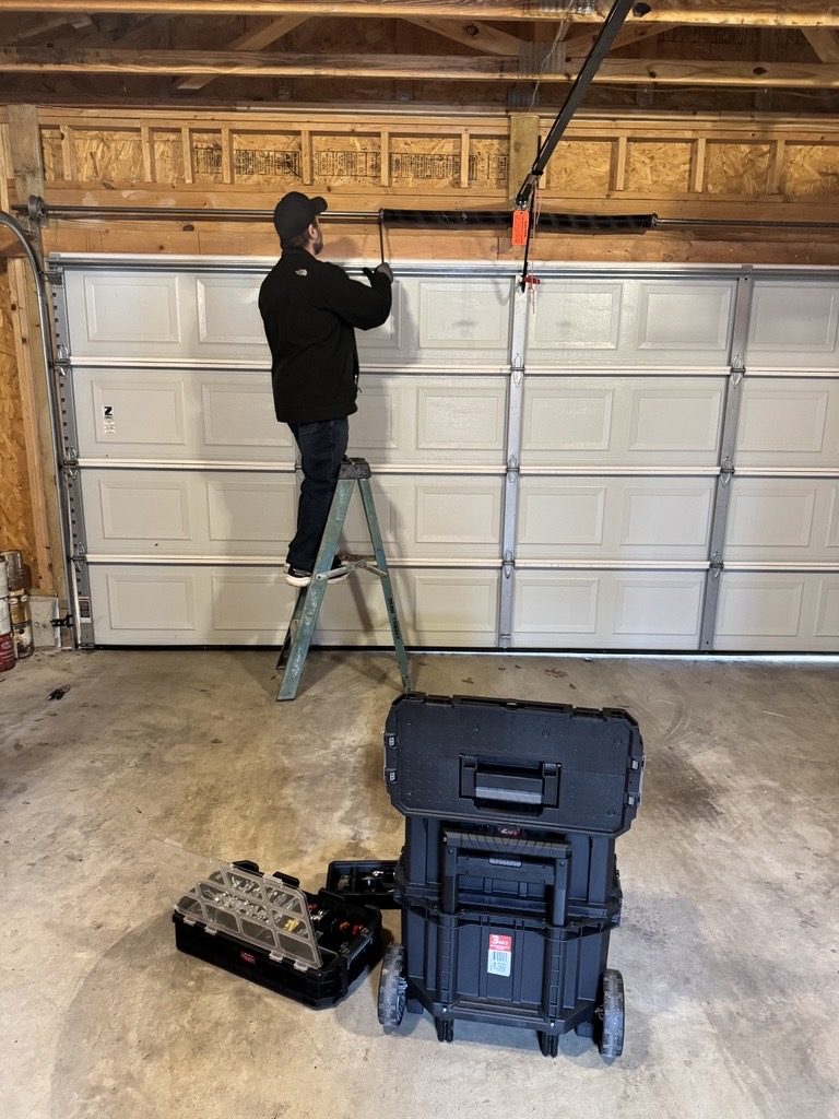 Garage door service and adjustment in progress