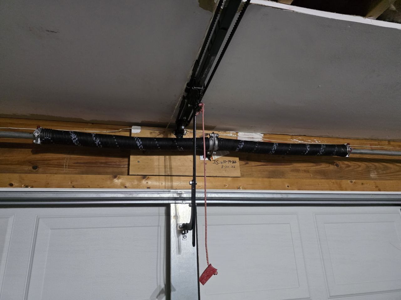 Garage door torsion spring shaft and opener arm after service