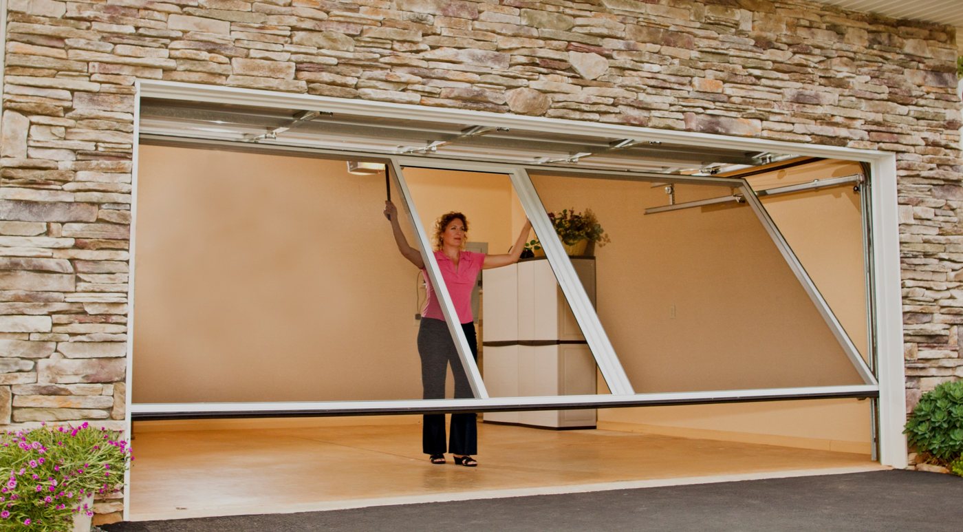 Lifestyle garage screen being lowered inside a garage door opening