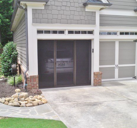 Lifestyle garage screen on brick home garage opening